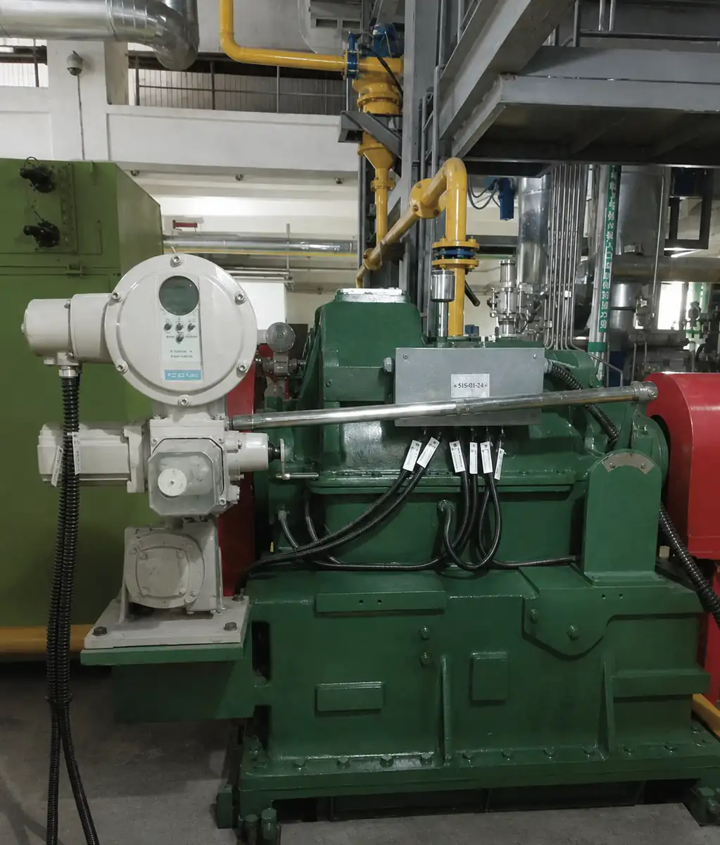 Electric valve actuators installed beside industrial equipment